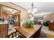 Dining area with hardwood floors open to the kitchen and living room with natural light at 330 N Sunset Dr, Mount Dora, FL 32757