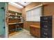 Practical garage workbench area with pegboard and shelving, perfect for DIY projects and efficient storage at 330 N Sunset Dr, Mount Dora, FL 32757