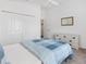 Bedroom featuring white walls, ceiling fan, blue and white bedding and carpeted floor at 3320 Davis Ter, The Villages, FL 32163