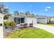 Charming single-story home with blue siding, manicured landscaping, and a white picket fence at 3320 Davis Ter, The Villages, FL 32163