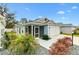 Cozy single-story home featuring a screened porch, manicured landscaping, and a white picket fence at 3320 Davis Ter, The Villages, FL 32163