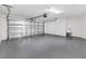 Spacious two car garage with durable epoxy flooring and convenient utility sink for easy cleanup at 3320 Davis Ter, The Villages, FL 32163