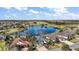 Beautiful aerial view of home overlooking a serene lake and lush golf course at 3426 Boardroom Trl, The Villages, FL 32163