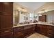 Bathroom vanity with granite counters and custom wood cabinets at 3426 Boardroom Trl, The Villages, FL 32163