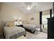 Comfortable bedroom with two twin beds and neutral decor at 3426 Boardroom Trl, The Villages, FL 32163