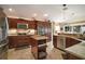 Well-equipped kitchen with stainless steel appliances and custom wood cabinetry at 3426 Boardroom Trl, The Villages, FL 32163