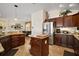 Open-concept kitchen with stainless steel appliances and granite counters at 3426 Boardroom Trl, The Villages, FL 32163