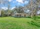 A well-maintained backyard featuring lush greenery and a sunroom for enjoying outdoor living at 422 W Hunt Ave, Bushnell, FL 33513