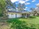 A quaint backyard with a sunroom addition, offering a serene outdoor space at 422 W Hunt Ave, Bushnell, FL 33513