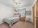 A comfortable bedroom with a bed, ceiling fan, and soft carpeting offers a relaxing retreat with natural light at 422 W Hunt Ave, Bushnell, FL 33513