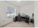 Bedroom featuring a desk, chair, and computer setup, creating a dedicated workspace with natural light from the window at 422 W Hunt Ave, Bushnell, FL 33513