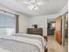 Bedroom featuring a wooden bed frame, soft carpeting, ceiling fan, and dresser provides a comfortable retreat at 422 W Hunt Ave, Bushnell, FL 33513