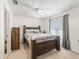 Bedroom featuring a wooden bed frame, soft carpeting, a ceiling fan, and natural light from the window at 422 W Hunt Ave, Bushnell, FL 33513