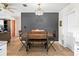 Dining area featuring a wooden table, industrial chairs, and a view to the living room at 422 W Hunt Ave, Bushnell, FL 33513