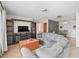 Cozy living room featuring a large sofa, a television, and tile floors at 422 W Hunt Ave, Bushnell, FL 33513