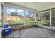 Relaxing sunroom with tile flooring, offering backyard views and a space for leisure at 422 W Hunt Ave, Bushnell, FL 33513