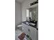 Updated bathroom with a vanity, black countertop, and a stylish shower with a marble tile surround at 42329 Chinaberry St, Eustis, FL 32736