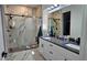 Bathroom featuring white cabinetry, double sinks, and a glass enclosed shower at 42329 Chinaberry St, Eustis, FL 32736