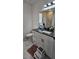 Updated bathroom with vanity, black countertop, and stylish shower with marble tile surround at 42329 Chinaberry St, Eustis, FL 32736