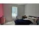 Cozy bedroom featuring marble tile floors and a vibrant pink accent wall at 42329 Chinaberry St, Eustis, FL 32736