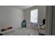 Bright bedroom with decorative butterfly curtains and marble tile flooring at 42329 Chinaberry St, Eustis, FL 32736