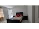 Bright bedroom featuring marble floors, king bed, and views of the property at 42329 Chinaberry St, Eustis, FL 32736
