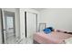Bedroom with sliding closet doors, a mirror, and marble tile flooring at 42329 Chinaberry St, Eustis, FL 32736