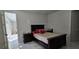 Relaxing bedroom featuring a king-sized bed, marble tile flooring, and bright lighting at 42329 Chinaberry St, Eustis, FL 32736