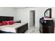 Bedroom featuring a dark wood bed frame, white walls, and marble floors at 42329 Chinaberry St, Eustis, FL 32736