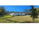 Side view of the home and detached garage, showcasing the expansive lawn at 42329 Chinaberry St, Eustis, FL 32736