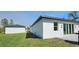 A view of the side of the house from the backyard featuring the patio at 42329 Chinaberry St, Eustis, FL 32736