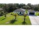 Modern home with a well-manicured lawn and a detached garage at 42329 Chinaberry St, Eustis, FL 32736