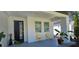 Covered front porch with modern minimalist design, furniture, and decor at 42329 Chinaberry St, Eustis, FL 32736