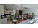 Bright living room open to kitchen area with modern light fixture above the dining table at 42329 Chinaberry St, Eustis, FL 32736