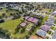 Aerial view of tennis and bocce ball courts, with well-manicured lawns and surrounding homes in a vibrant community at 4331 Arlington Ridge Blvd, Leesburg, FL 34748