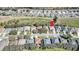 Aerial view of homes in a neighborhood, near a golf course with mature trees at 4331 Arlington Ridge Blvd, Leesburg, FL 34748