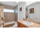 Bathroom featuring a shower-tub combo, vanity with sink, and neutral tile at 4331 Arlington Ridge Blvd, Leesburg, FL 34748