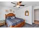 Cozy bedroom features a wood-framed bed, carpeted floors, and natural light at 4331 Arlington Ridge Blvd, Leesburg, FL 34748