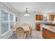 Breakfast nook and kitchen featuring a dining table for six, a window, and granite countertops at 4331 Arlington Ridge Blvd, Leesburg, FL 34748