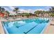 The community pool features lane lines, surrounding palm trees, ample seating, and a relaxing atmosphere for residents at 4331 Arlington Ridge Blvd, Leesburg, FL 34748