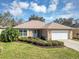 Charming single-story home with a well-manicured lawn, a two-car garage, and beautiful landscaping at 4331 Arlington Ridge Blvd, Leesburg, FL 34748