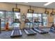 Treadmills facing large windows with TV's for entertainment while overlooking the community pool at 4331 Arlington Ridge Blvd, Leesburg, FL 34748