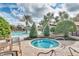 Relaxing hot tub near the community pool with lush landscaping, seating, and a tranquil setting for unwinding after a long day at 4331 Arlington Ridge Blvd, Leesburg, FL 34748