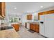 Kitchen and breakfast nook featuring a cooktop, granite countertops, a white refrigerator, and a view to the lawn at 4331 Arlington Ridge Blvd, Leesburg, FL 34748