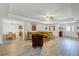 Open concept living room featuring wood floors, recessed lighting, a sofa, and an entryway at 4331 Arlington Ridge Blvd, Leesburg, FL 34748