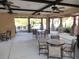 Inviting poolside seating area with tables, chairs, overhead fans, and stone pillars for residents' comfort and enjoyment at 4331 Arlington Ridge Blvd, Leesburg, FL 34748