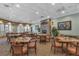 Cozy dining room with stone fireplace and comfortable seating at 4331 Arlington Ridge Blvd, Leesburg, FL 34748