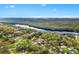 A scenic aerial view of the property surrounded by lush greenery and waterfront views at 4552 Cr 300, Lake Panasoffkee, FL 33538