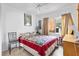 The bedroom has a large window that lets in plenty of light and is decorated with a vintage lamp at 4552 Cr 300, Lake Panasoffkee, FL 33538