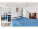 This bedroom is well-lit with light colored walls and a metal bed frame with a blue comforter at 4552 Cr 300, Lake Panasoffkee, FL 33538